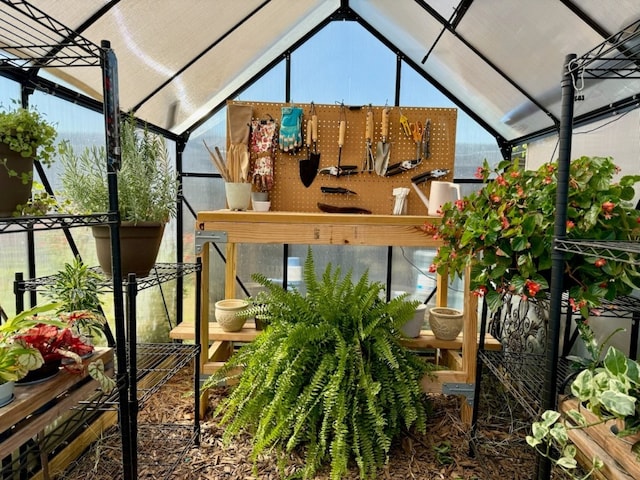 sunroom / solarium featuring lofted ceiling