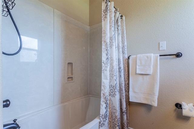 bathroom with shower / bath combo with shower curtain