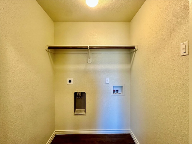 washroom featuring hookup for a washing machine, electric dryer hookup, a textured ceiling, and dark hardwood / wood-style flooring