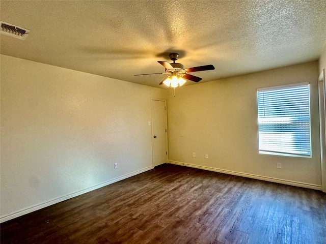 spare room featuring a textured ceiling, ceiling fan, and dark hardwood / wood-style floors