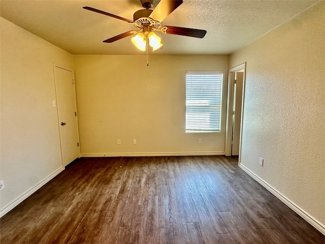 empty room with ceiling fan, a textured ceiling, and dark hardwood / wood-style flooring