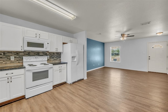 kitchen with white appliances, light hardwood / wood-style floors, a textured ceiling, and white cabinets