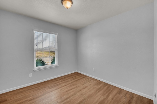 unfurnished room featuring hardwood / wood-style flooring