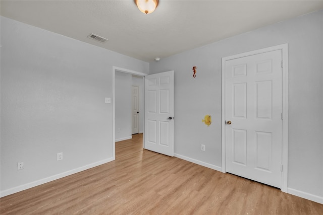 unfurnished bedroom featuring light wood-type flooring