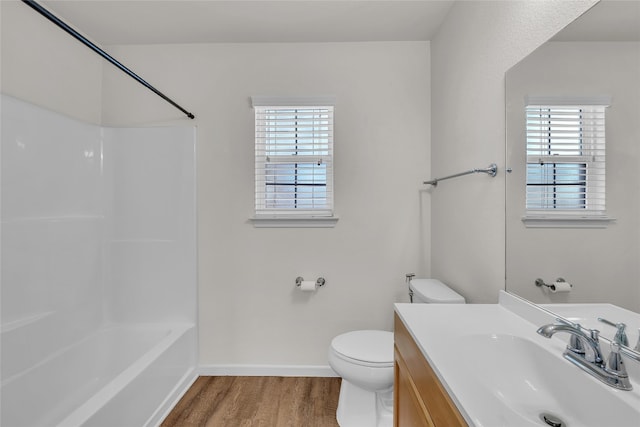 full bathroom with shower / bathtub combination, wood-type flooring, toilet, and plenty of natural light