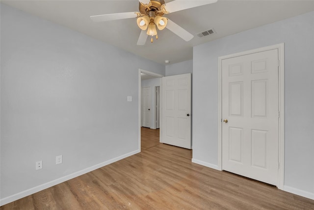 unfurnished bedroom with ceiling fan and light wood-type flooring