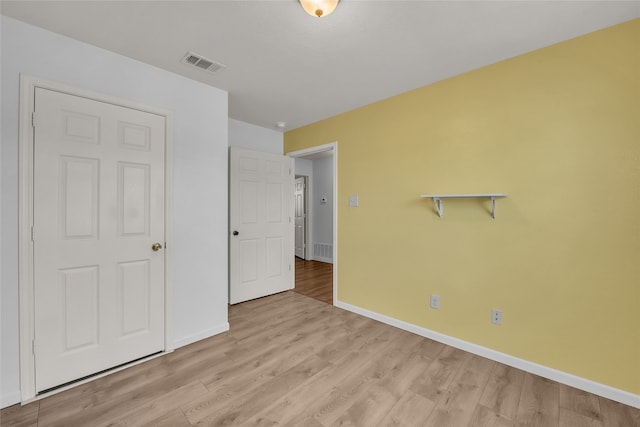 unfurnished bedroom with light wood-type flooring