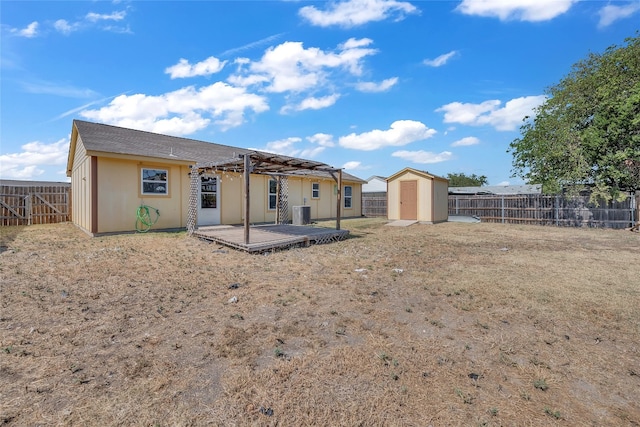 rear view of property with a patio area and a shed