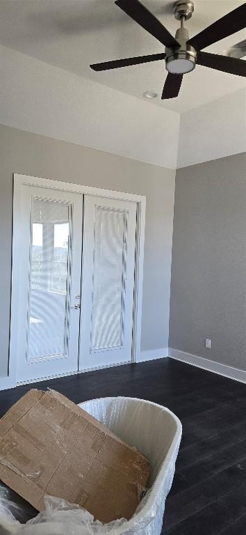 foyer with lofted ceiling, baseboards, dark wood finished floors, and a ceiling fan