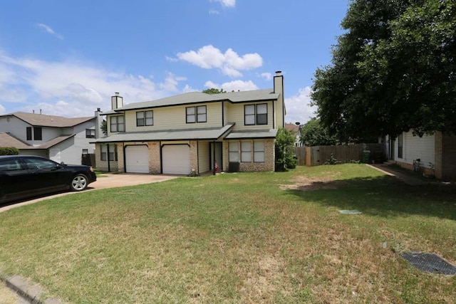 view of property featuring a front lawn and a garage