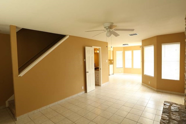 tiled empty room with ceiling fan