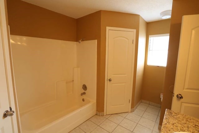 bathroom featuring vanity, tile patterned floors, shower / tub combination, and a textured ceiling