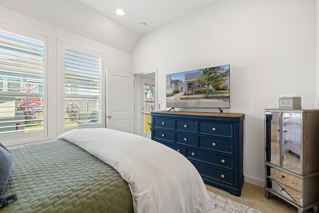 bedroom featuring light carpet and lofted ceiling