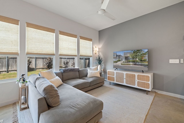 living room featuring ceiling fan and a wealth of natural light