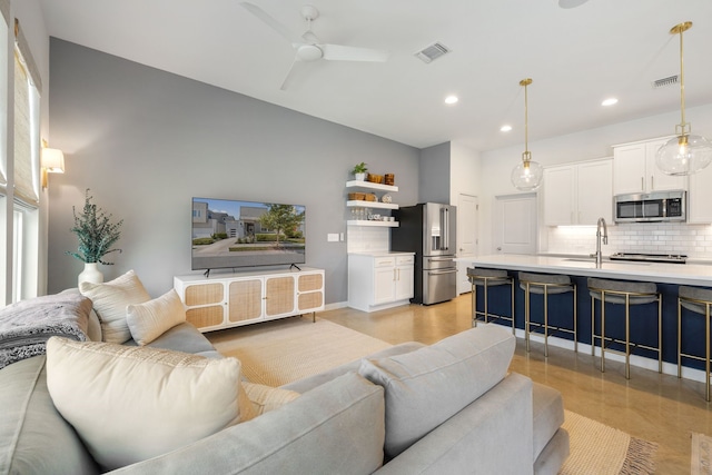 living room featuring sink and ceiling fan