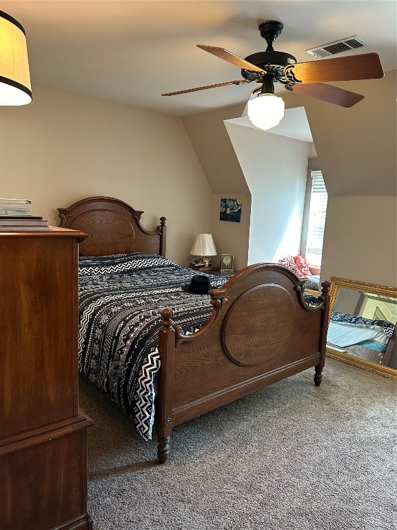 bedroom with dark carpet, lofted ceiling, and ceiling fan