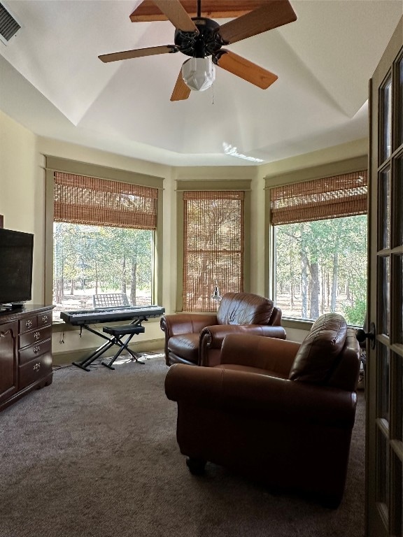 living room with lofted ceiling, carpet, and a wealth of natural light