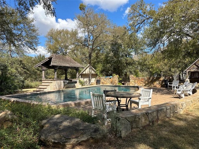 view of swimming pool with a patio area