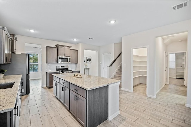 309 Greenway Dr, Georgetown, TX 78628 - kitchen featuring a kitchen island, visible vents, appliances with stainless steel finishes, and baseboards