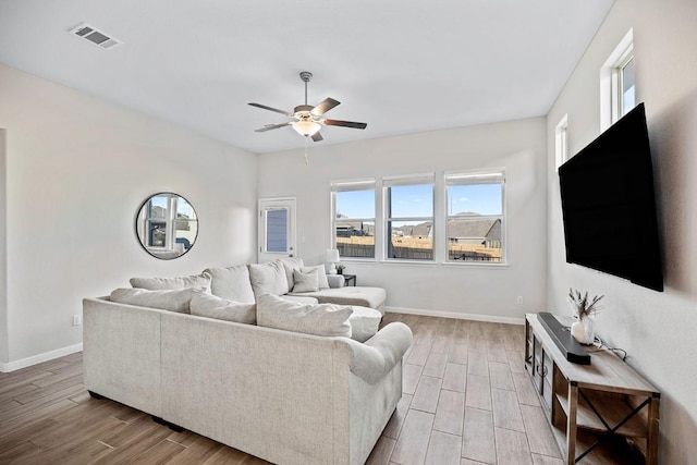 309 Greenway Dr, Georgetown, TX 78628 - living room featuring light wood finished floors, baseboards, visible vents, and ceiling fan