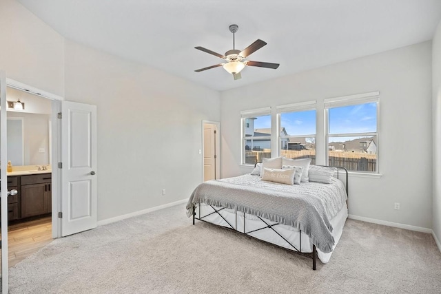 309 Greenway Dr, Georgetown, TX 78628 - bedroom featuring baseboards, connected bathroom, light colored carpet, and a sink