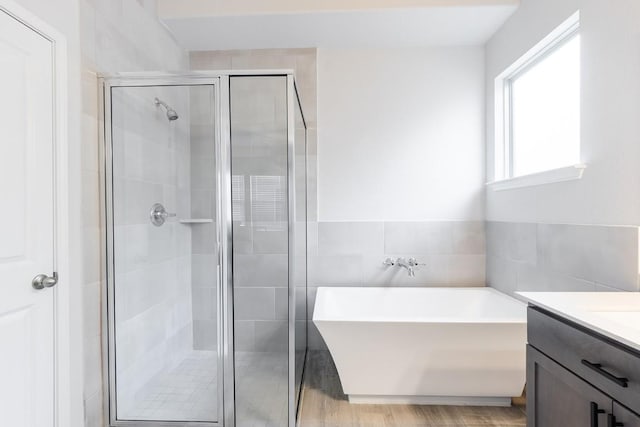309 Greenway Dr, Georgetown, TX 78628 - bathroom with a freestanding bath, tile walls, a shower stall, and vanity