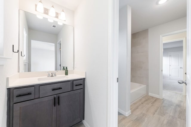 bathroom with vanity and hardwood / wood-style flooring