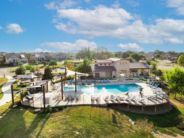 view of pool with a patio area and a yard