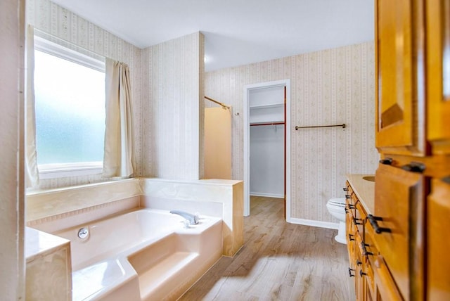 298 Jenkins Rd, Cedar Creek, TX 78612 - bathroom with wallpapered walls, a bath, wood finished floors, toilet, and a shower