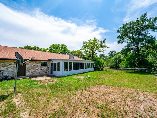 298 Jenkins Rd, Cedar Creek, TX 78612 - back of house with stone siding, a sunroom, a chimney, and a patio