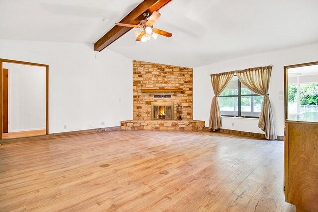 298 Jenkins Rd, Cedar Creek, TX 78612 - unfurnished living room with wood finished floors, ceiling fan, and a large fireplace