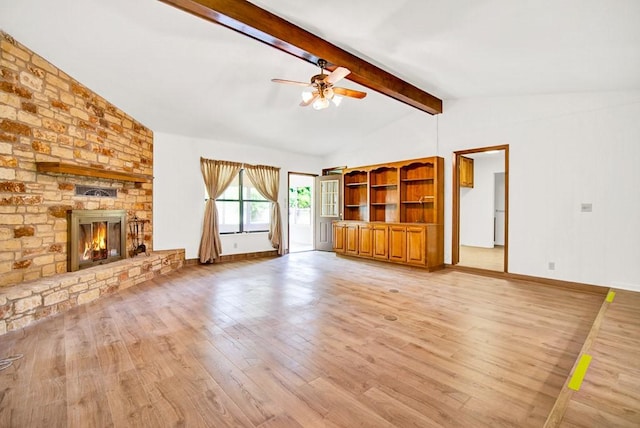 298 Jenkins Rd, Cedar Creek, TX 78612 - unfurnished living room with ceiling fan, light wood-type flooring, and a large fireplace