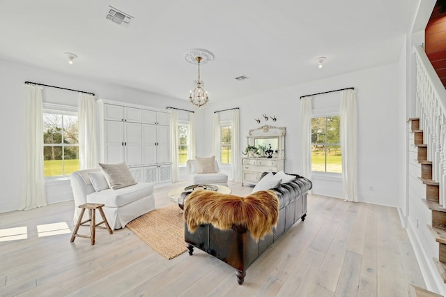 233 W Mill St, Round Top, TX 78954 - living room with a chandelier, light wood-style floors, and stairway