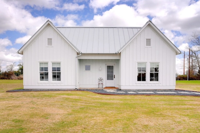 rear view of house featuring a lawn