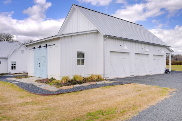 view of side of property featuring a yard and a garage