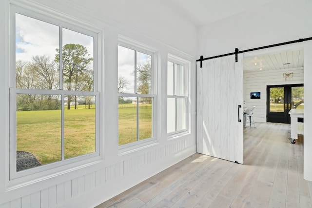 sunroom / solarium featuring a barn door