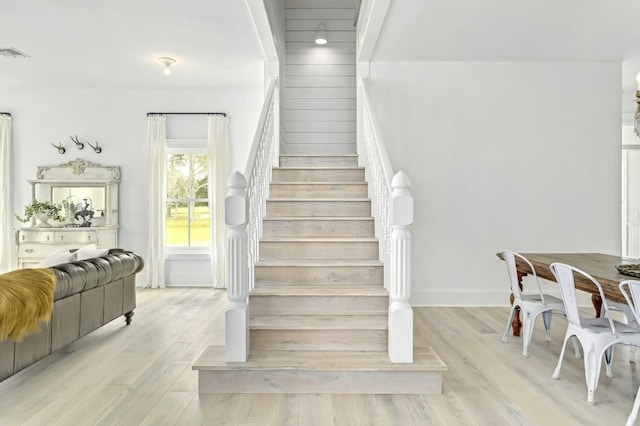 stairs featuring hardwood / wood-style floors