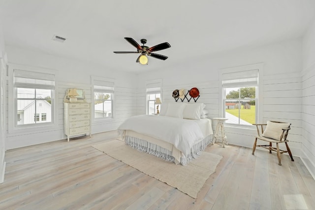 233 W Mill St, Round Top, TX 78954 - bedroom with multiple windows, wood finished floors, and a ceiling fan