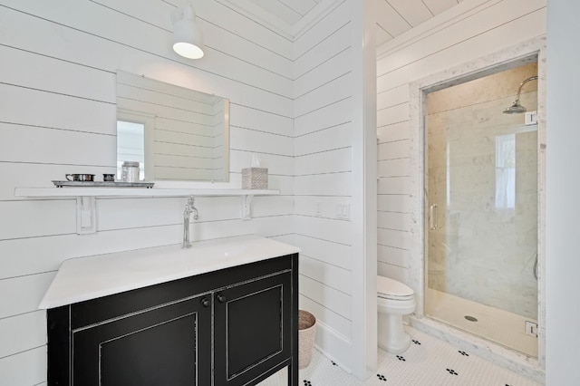 bathroom featuring toilet, vanity, an enclosed shower, wooden walls, and tile patterned flooring