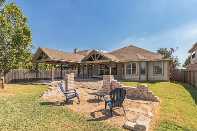 back of property with an outdoor fire pit, a patio area, and a lawn