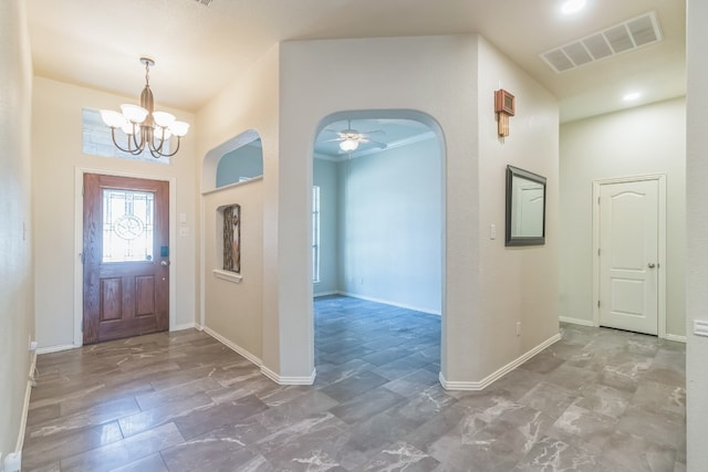 entrance foyer featuring ceiling fan with notable chandelier