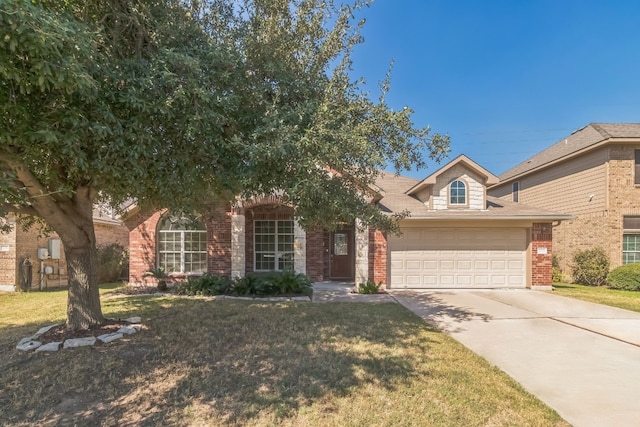 view of front of property featuring a front lawn and a garage