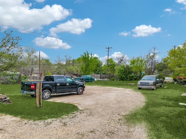 view of vehicle parking featuring a yard