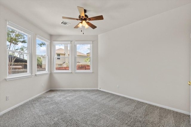 carpeted empty room featuring ceiling fan