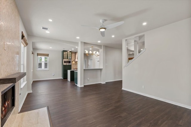 unfurnished living room with ceiling fan and dark hardwood / wood-style flooring