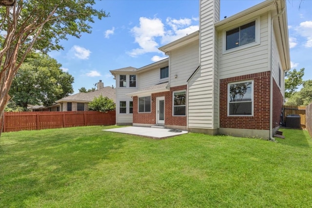 back of house with a patio, a yard, and central air condition unit