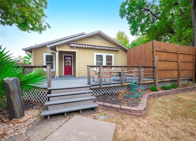 rear view of house with a wooden deck