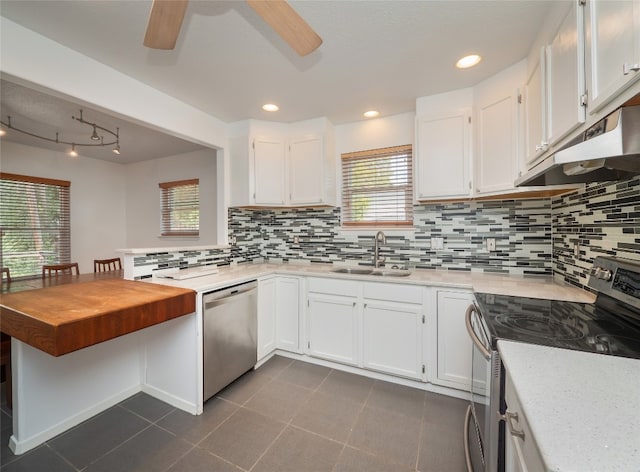 kitchen featuring appliances with stainless steel finishes, white cabinets, sink, and plenty of natural light