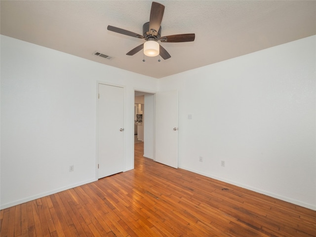 spare room with hardwood / wood-style floors and ceiling fan