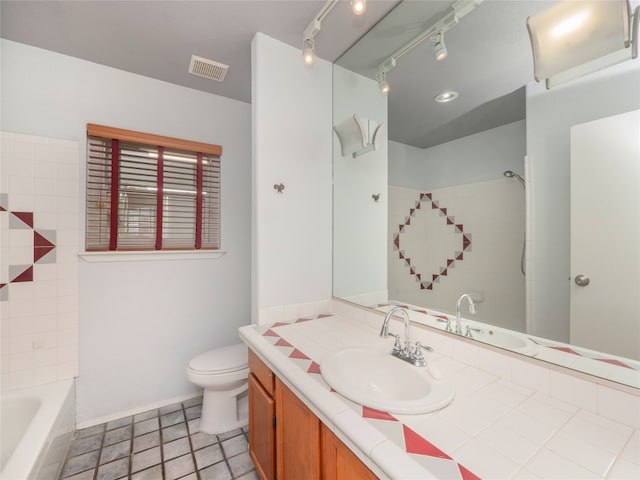 bathroom with vanity, rail lighting, and toilet